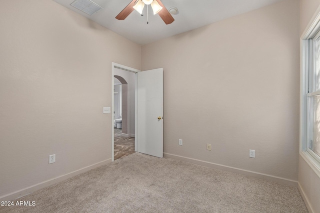 unfurnished room with ceiling fan and light colored carpet