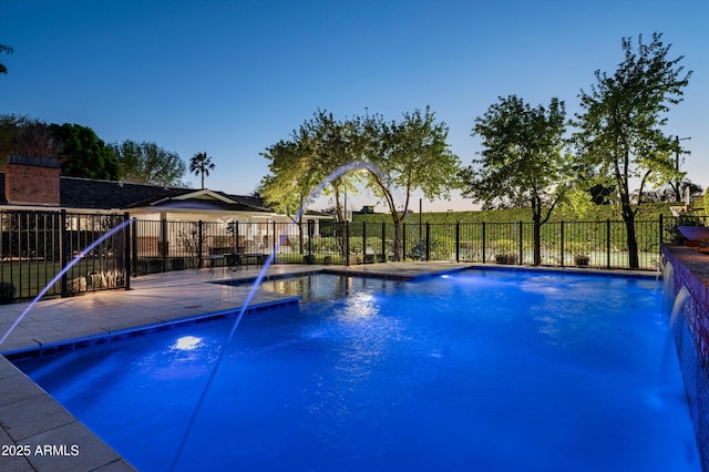 pool at dusk featuring a fenced in pool, fence, and a patio