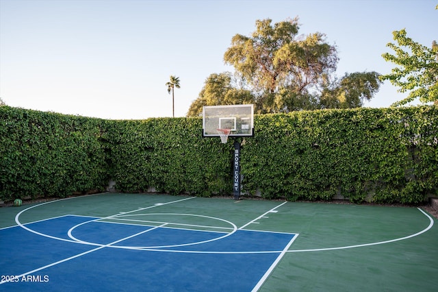 view of sport court featuring basketball court and fence