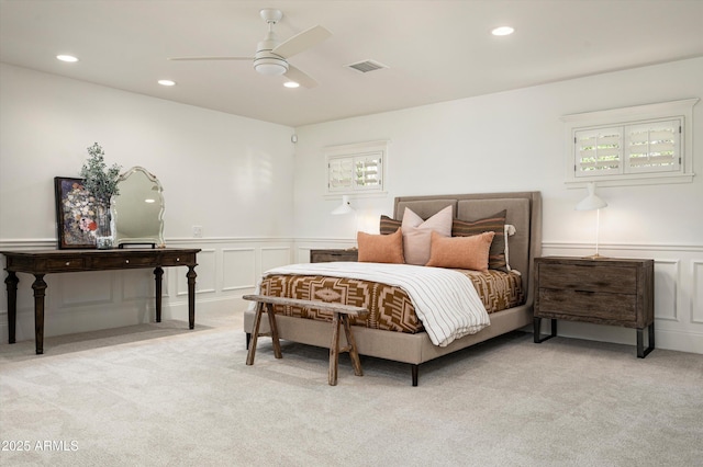 bedroom with a wainscoted wall, light colored carpet, visible vents, and recessed lighting