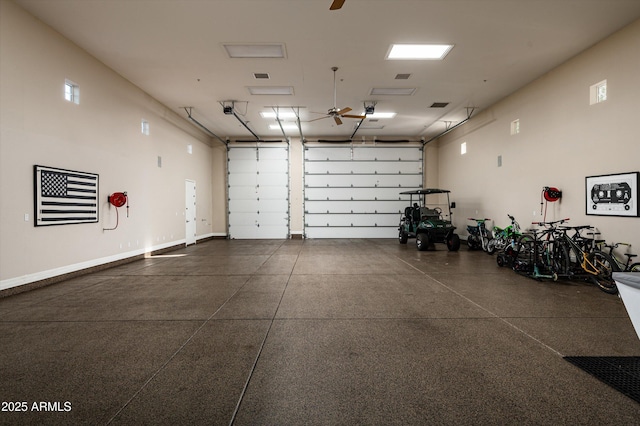 garage with baseboards and ceiling fan