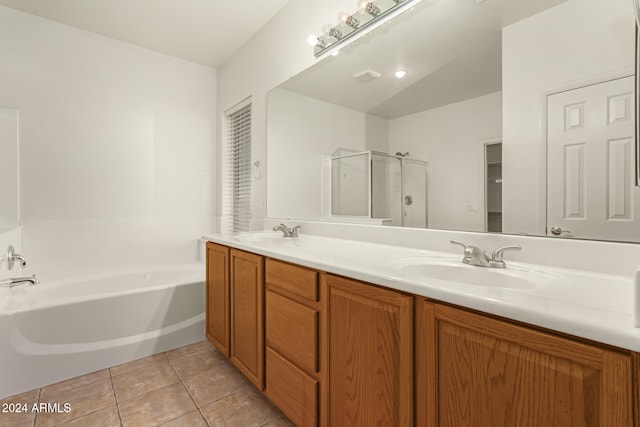 bathroom featuring vanity, vaulted ceiling, separate shower and tub, and tile patterned flooring