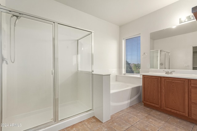 bathroom with tile patterned flooring, separate shower and tub, and vanity