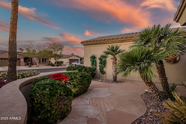 view of patio / terrace with a garage and concrete driveway