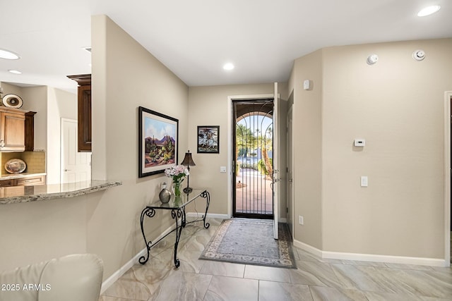 entryway featuring recessed lighting and baseboards