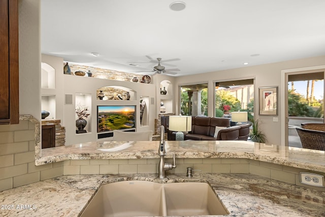 kitchen with a wealth of natural light, open floor plan, and a sink