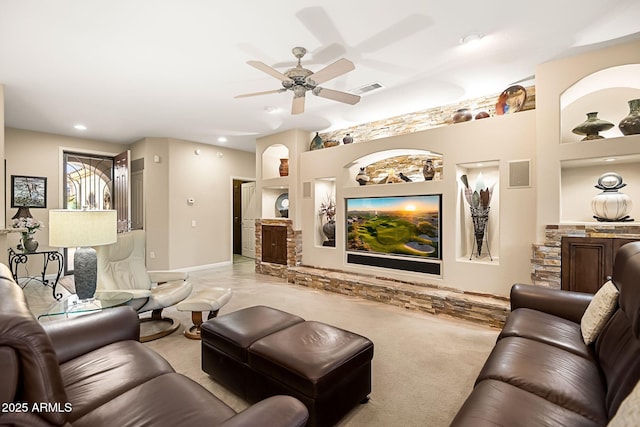 carpeted living area featuring a ceiling fan, visible vents, and baseboards