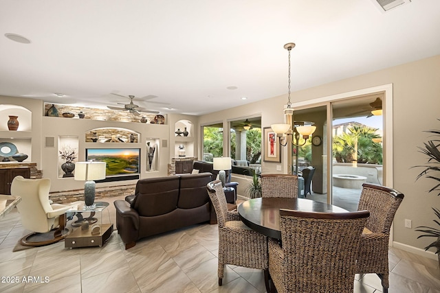 dining area with built in features, visible vents, and a ceiling fan