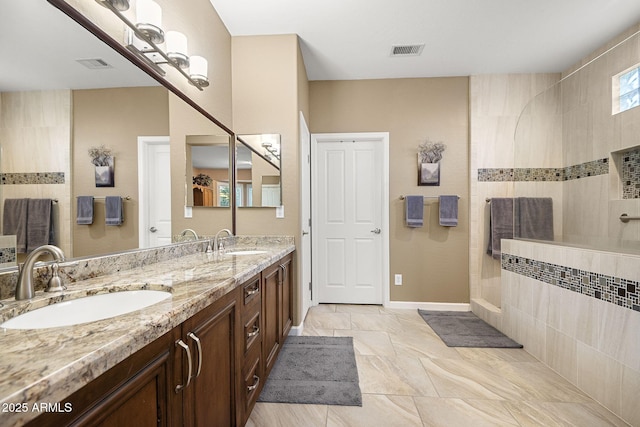 full bathroom with a sink, visible vents, and a walk in shower