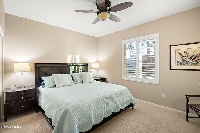 bedroom featuring baseboards, light carpet, and ceiling fan