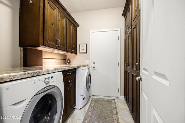 washroom featuring cabinet space and washer and dryer