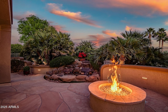 patio terrace at dusk with an outdoor fire pit