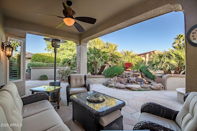 view of patio / terrace featuring an outdoor hangout area, fence, and ceiling fan