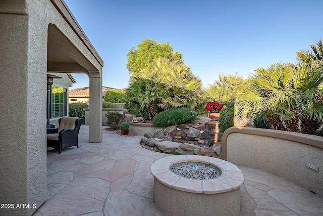 view of patio with a fire pit