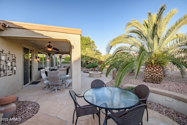 view of patio / terrace featuring outdoor dining area and a ceiling fan