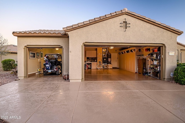 garage featuring concrete driveway