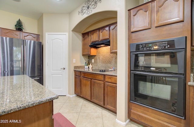 708 E Dry Creek Rd, San Tan Valley, AZ 85143 - kitchen featuring black appliances, backsplash, light tile patterned flooring, and light stone countertops
