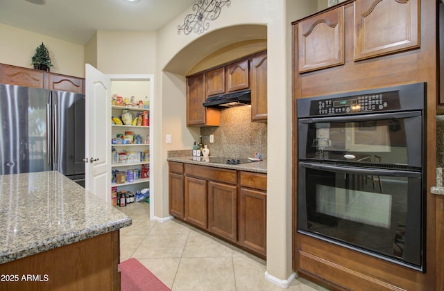 708 E Dry Creek Rd, San Tan Valley, AZ 85143 - kitchen with black appliances, decorative backsplash, under cabinet range hood, and light stone countertops