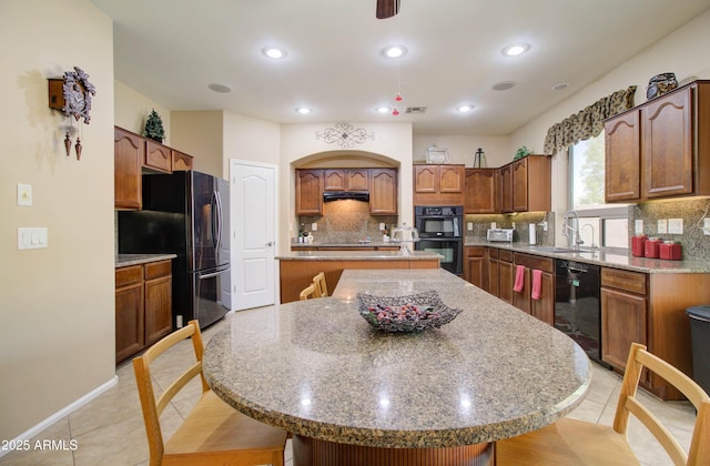708 E Dry Creek Rd, San Tan Valley, AZ 85143 - kitchen with black appliances, a kitchen island, tasteful backsplash, light tile patterned floors, and recessed lighting