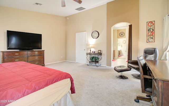 708 E Dry Creek Rd, San Tan Valley, AZ 85143 - bedroom with arched walkways, carpet floors, ensuite bath, and a ceiling fan