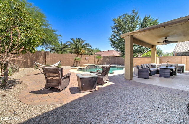 708 E Dry Creek Rd, San Tan Valley, AZ 85143 - fenced backyard with an outdoor living space with a fire pit, a patio area, and a ceiling fan