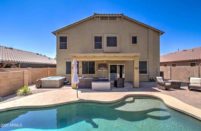 708 E Dry Creek Rd, San Tan Valley, AZ 85143 - back of property featuring a hot tub, an outdoor living space, a fenced backyard, stucco siding, and a patio