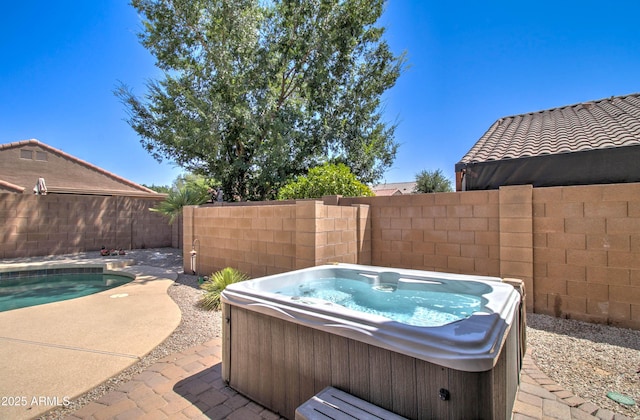 708 E Dry Creek Rd, San Tan Valley, AZ 85143 - fenced backyard featuring a hot tub and a patio area
