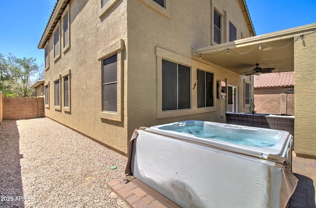 708 E Dry Creek Rd, San Tan Valley, AZ 85143 - back of property with a hot tub, ceiling fan, stucco siding, and a fenced backyard