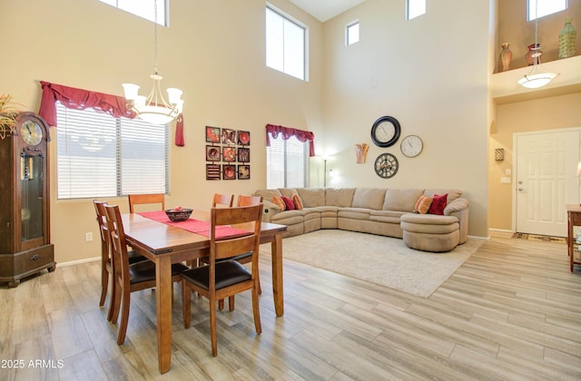 708 E Dry Creek Rd, San Tan Valley, AZ 85143 - dining area with a high ceiling, a chandelier, and light wood-style floors