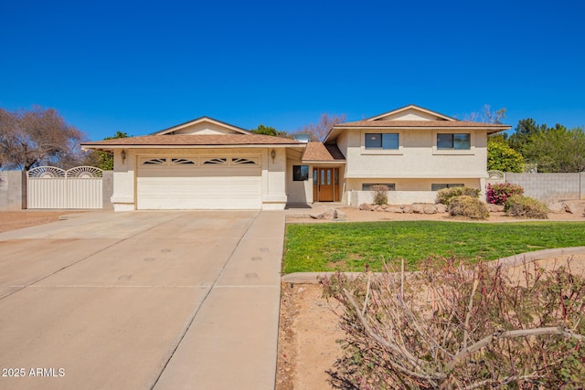 tri-level home featuring stucco siding, a gate, fence, a garage, and driveway