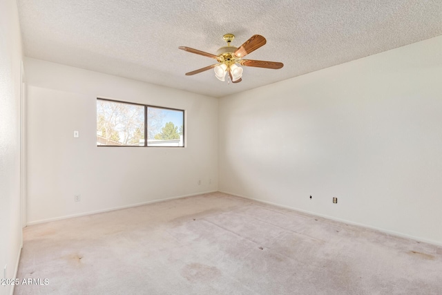 unfurnished room with light carpet, ceiling fan, a textured ceiling, and baseboards