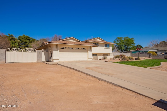 view of front of home featuring concrete driveway, an attached garage, a gate, fence, and stucco siding