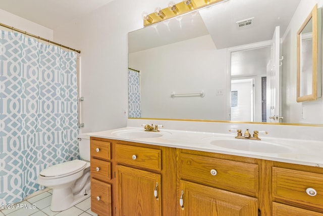 full bathroom featuring double vanity, a sink, toilet, and tile patterned floors