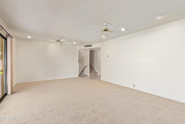 spare room featuring recessed lighting, visible vents, light colored carpet, ceiling fan, and a textured ceiling