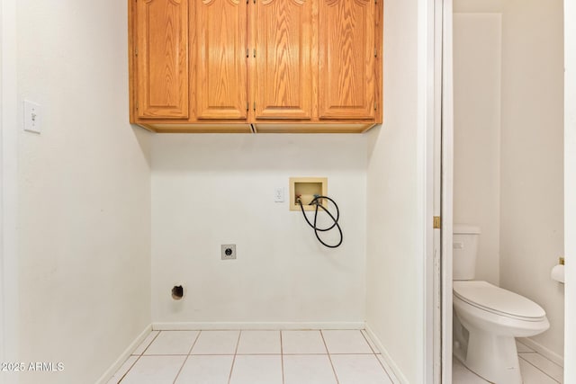 laundry room featuring washer hookup, cabinet space, light tile patterned flooring, electric dryer hookup, and baseboards