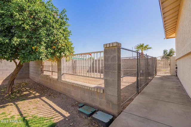 view of gate featuring a fenced backyard