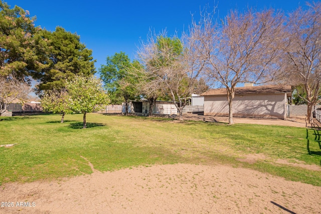 view of yard featuring fence and an outdoor structure