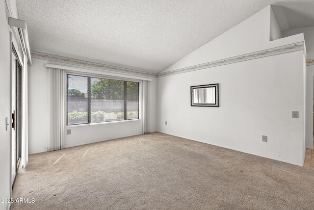 carpeted empty room featuring a textured ceiling and lofted ceiling