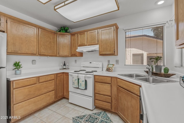 kitchen with light tile patterned floors, a sink, light countertops, under cabinet range hood, and electric range