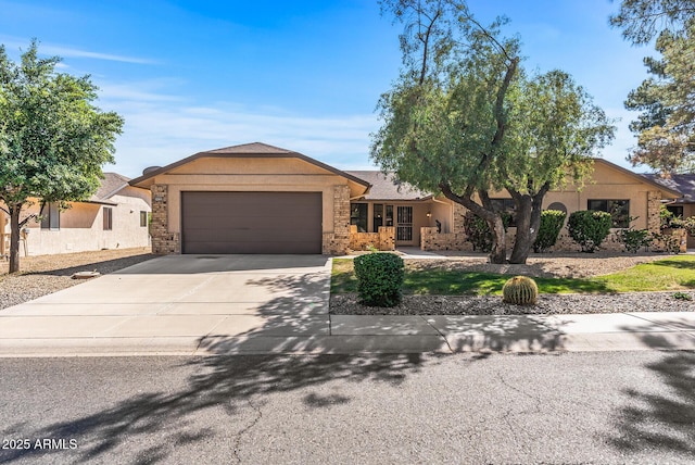 ranch-style house with an attached garage, concrete driveway, stucco siding, and stone siding