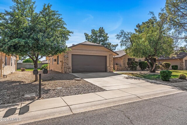 ranch-style house featuring driveway and a garage