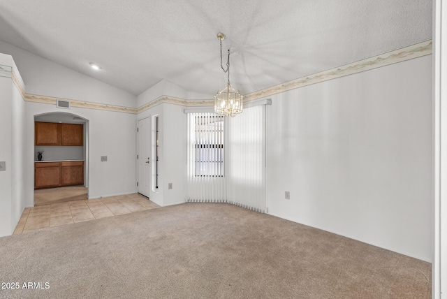 unfurnished dining area featuring visible vents, light tile patterned floors, a chandelier, light carpet, and lofted ceiling