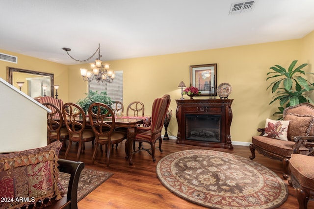 dining room featuring hardwood / wood-style floors and a notable chandelier