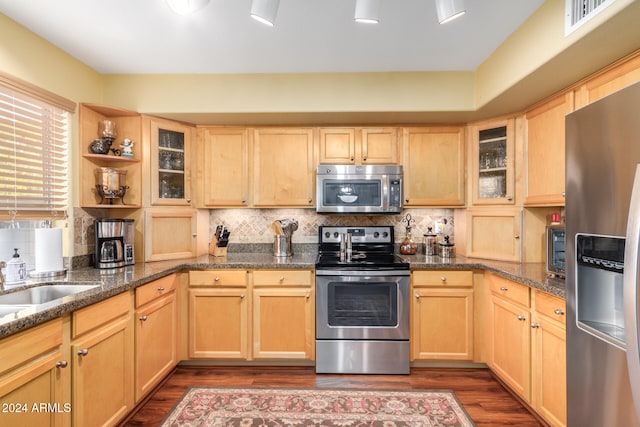 kitchen featuring dark hardwood / wood-style floors, light brown cabinetry, backsplash, and appliances with stainless steel finishes