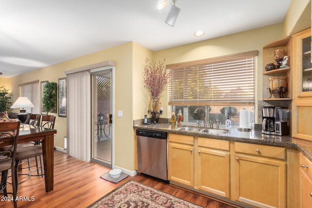 kitchen featuring dishwasher, sink, hardwood / wood-style floors, dark stone counters, and light brown cabinetry