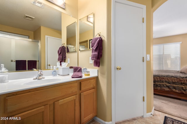 bathroom featuring vanity, tile patterned floors, and an enclosed shower