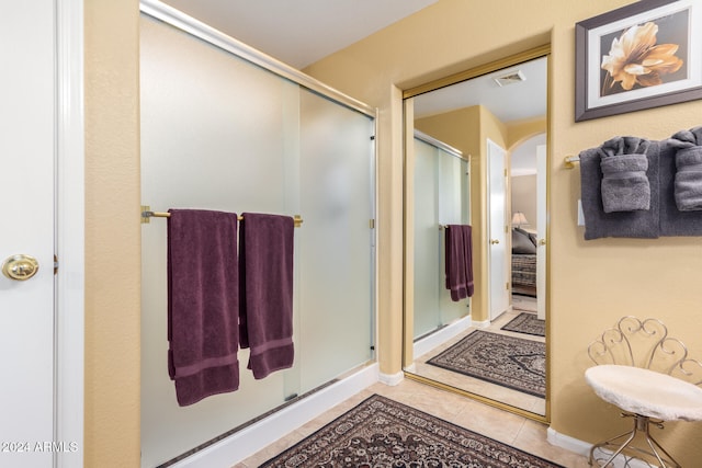 bathroom with tile patterned floors and an enclosed shower