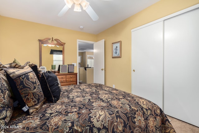 carpeted bedroom featuring ceiling fan and a closet