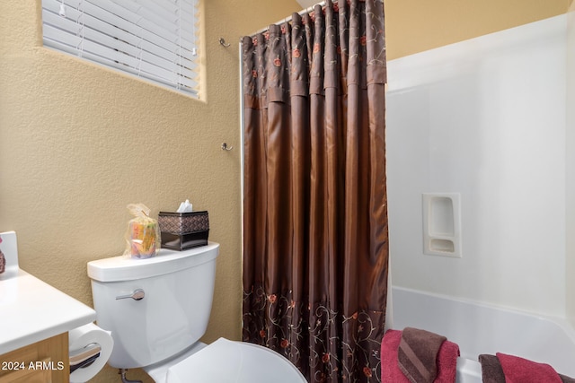 full bathroom with vanity, toilet, and shower / bath combo with shower curtain