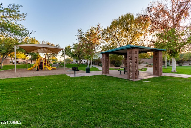 view of community featuring a gazebo, a playground, and a lawn